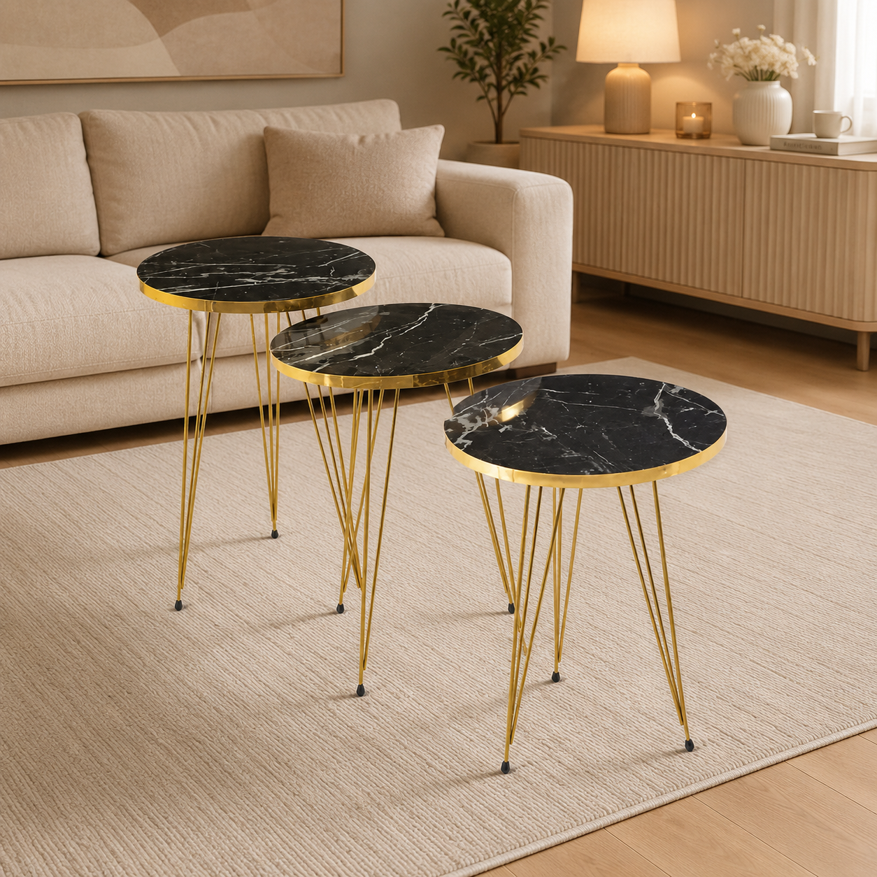 Three round side tables with black marble tops and gold metal legs in a living room setting.