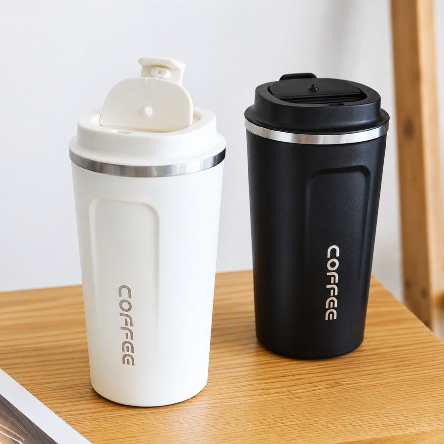 Black and white stainless steel coffee mugs side by side on a wooden table