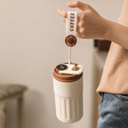 Cream and brown smart coffee mug held by wrist strap with COFFEE text and heart charm