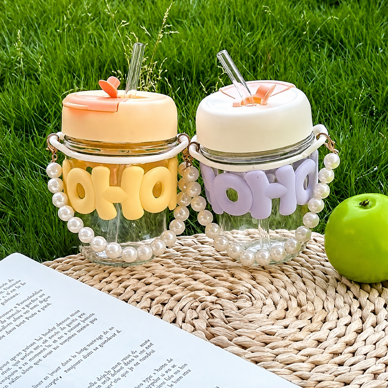 Two decorative jars with 'HO HO HO' text on a mate and grassy background