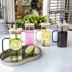 Set of glass mugs with various drinks and accessories on a table.