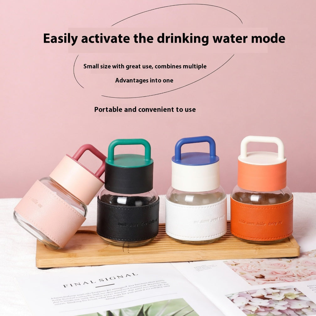 Four colorful water bottles with different colored lids on a wooden tray against a pink background.