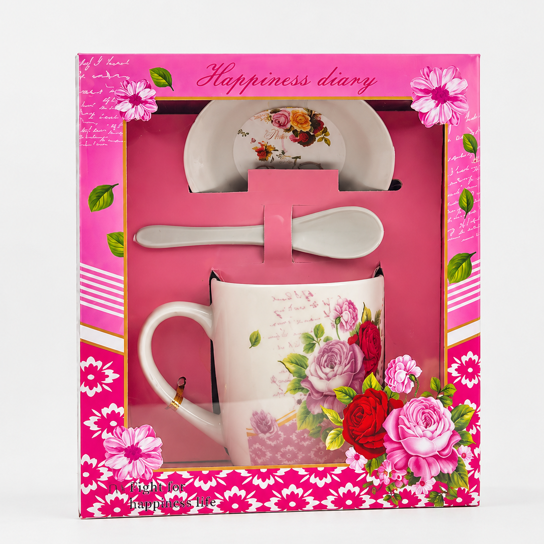Gift set with mug, spoon, and plate in a pink box with floral designs.