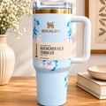 Stanley Quencher H2.0 tumbler in blue rose floral print with gold rim, styled with flowers