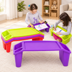 Two kids using purple and lime green lap desks to draw on rug