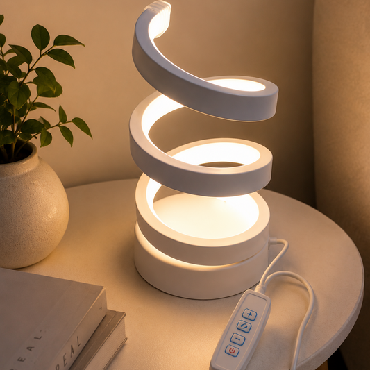 White spiral LED lamp glowing warm light on bedside table with plant and books