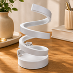 White spiral LED lamp off, styled on wooden desk with plant and pen holder