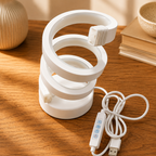 White spiral LED lamp turned off showing coiled design and USB touch remote
