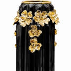 Black ceramic vase with gold flowers, front view on white background