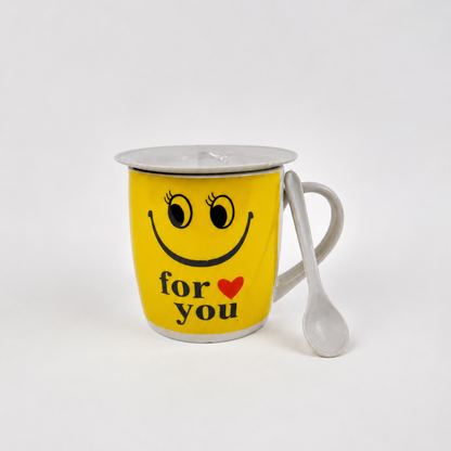 Yellow mug with smiley face, heart, and text 'for you' on a white background
